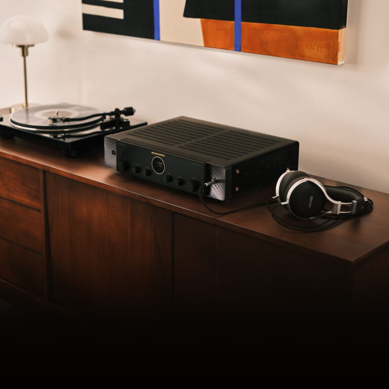 Silver-Gold Model 70 lifestyle image facing left sitting on wooden console
